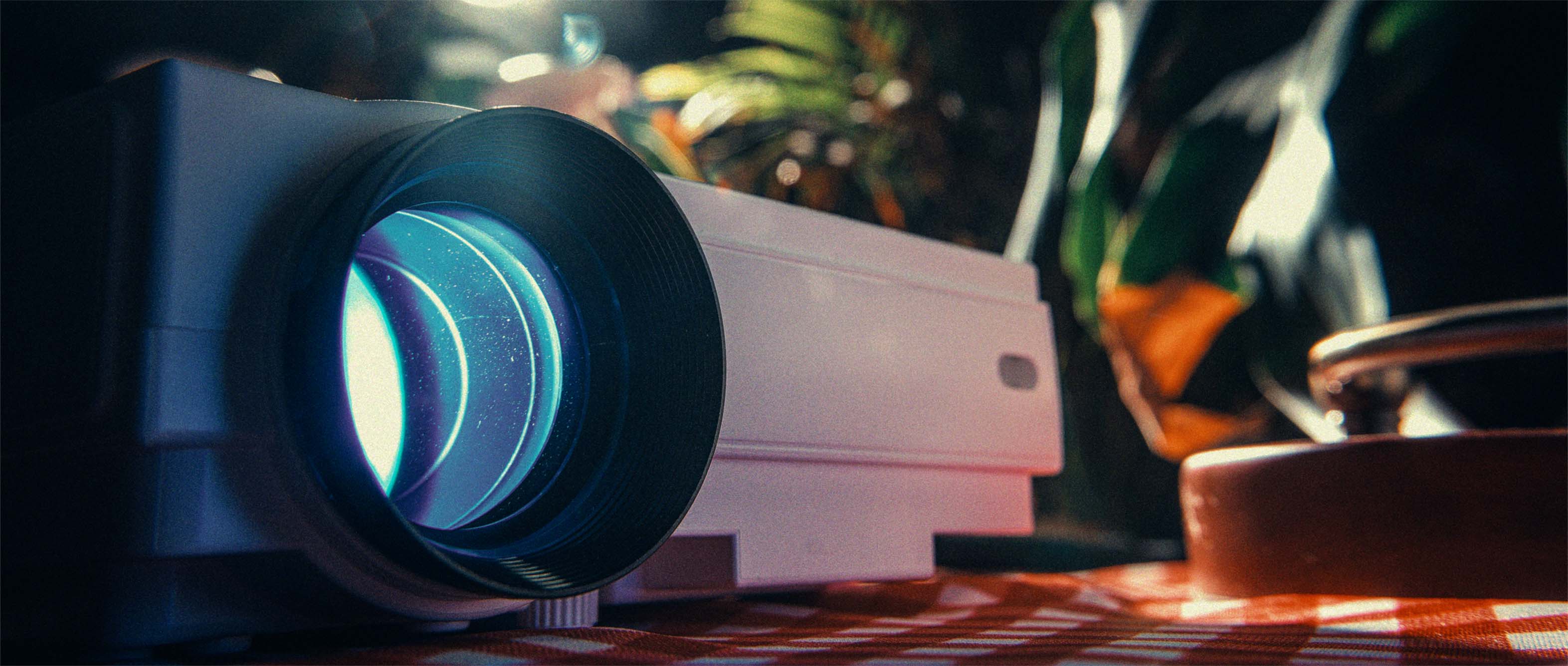 Vintage film projector on a table, red-tinted room