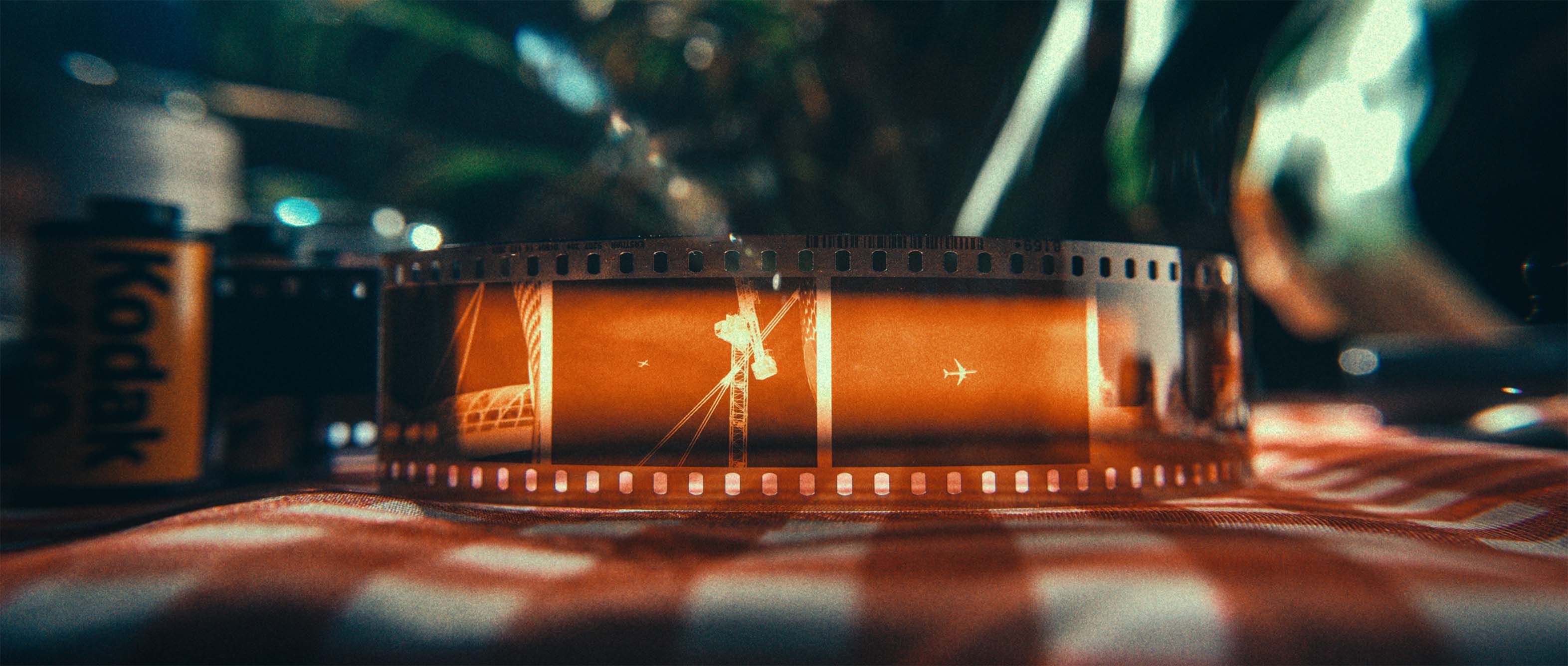 Backlit Kodak film strip on a checkered tablecloth
